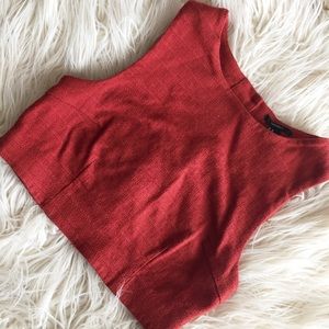 Rust colored crop top with button detailing back.